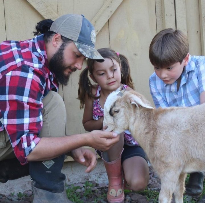 Kids at Camp White Stag get hands on experience caring for the farm animals.